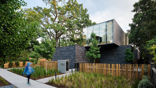 Exterior of a house with a fence in the front.